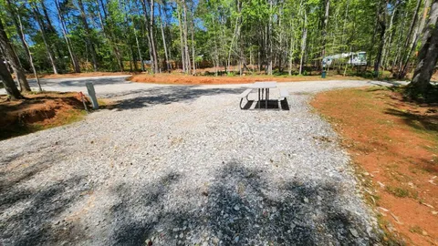 Campsite #5 RV/ Tent Site 30’ x 18’  Electric & Water Hookup, Level Gravel Pad with Back Yard andShaded Fenced Enclosure for your Pets, Back In — image 2 of 8