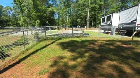 Campsite #9  RV/ Tent Site Full Hook Up 50’ x 18’ Level Gravel Pad with Fenced in Back Yard, Back In — image 2 of 9