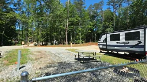 Campsite #9  RV/ Tent Site Full Hook Up 50’ x 18’ Level Gravel Pad with Fenced in Back Yard, Back In — image 2 of 9