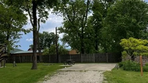 Deluxe Full Hookup Back In RV Site with Concrete Pad — image 1 of 27