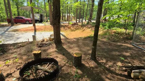 Campsite #4 RV /Tent Site Full Hook Up,  40’ x 18’  Level Gravel Pad with Back Yard and Shaded Fenced Enclosure for you Pets, Back In — image 2 of 13