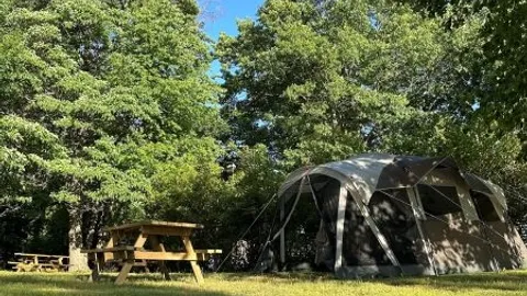 Ready to Camp Electric Pre-setup Tent w/ Cots - Sunset Lake View — image 1 of 7