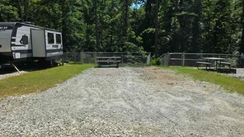 Campsite #9  RV/ Tent Site Full Hook Up 50’ x 18’ Level Gravel Pad with Fenced in Back Yard, Back In — image 1 of 9