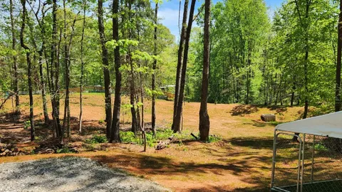 Campsite #5 RV/ Tent Site 30’ x 18’  Electric & Water Hookup, Level Gravel Pad with Back Yard andShaded Fenced Enclosure for your Pets, Back In — image 2 of 8