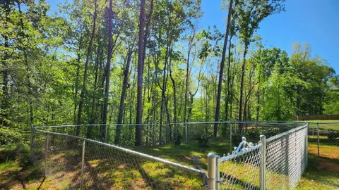 Campsite #8 RV/ Tent Site Full Hook Up 60’ x 18’ Level Gravel Pad with Fenced in Back Yard, Side Yard, Private path to trails, Back In — image 9 of 9